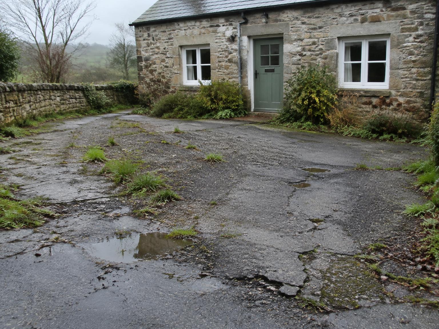 Same driveway before resurfacing, worn and cracked